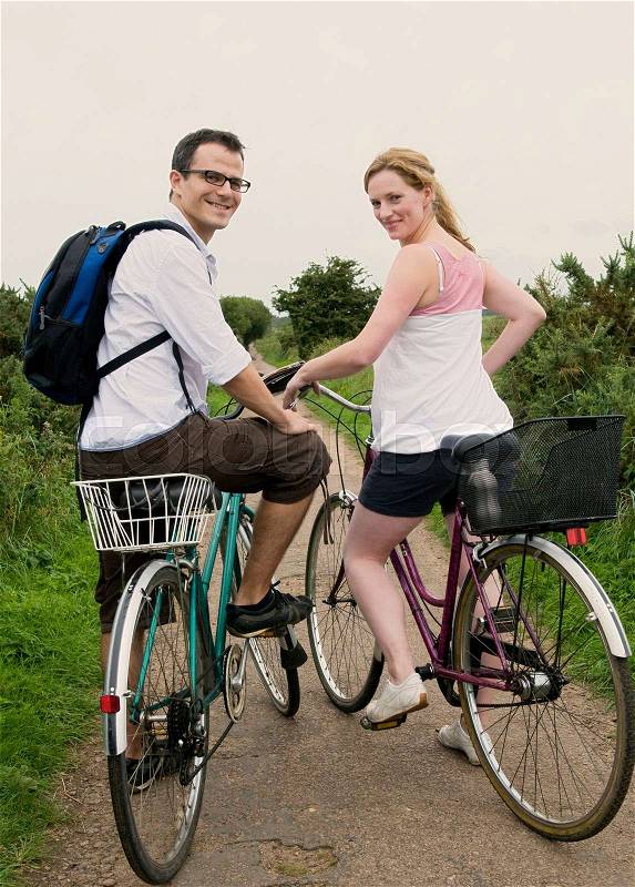Happy couple prepare to bicycle, stock photo