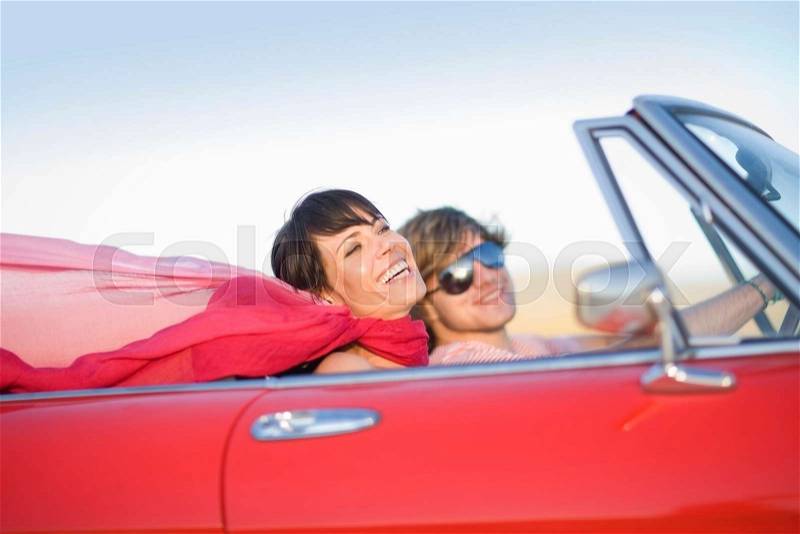 Woman and man in a convertible, stock photo