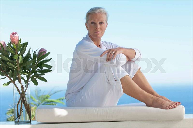 Older woman doing yoga, stock photo