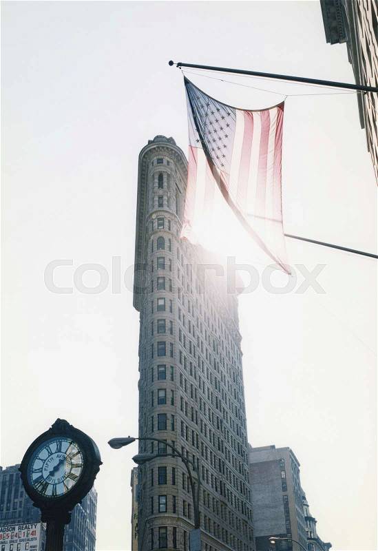 American flag hanging over city street, stock photo