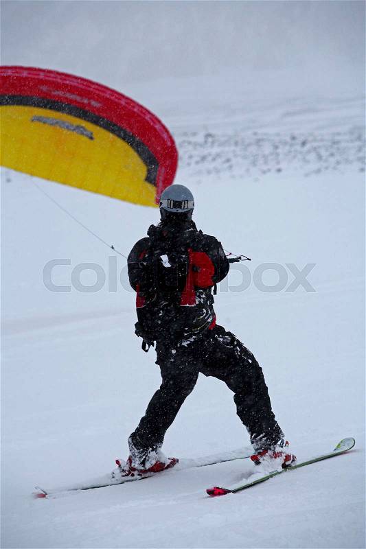 Man snow kiting in snow covered field, stock photo