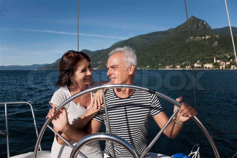 Older couple sailing together, stock photo