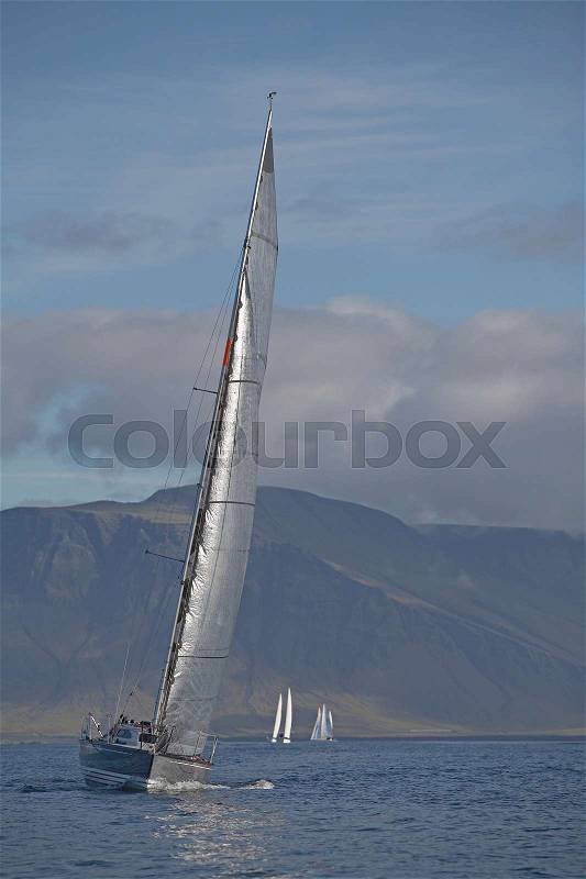 Sailboat tipping in wind, stock photo