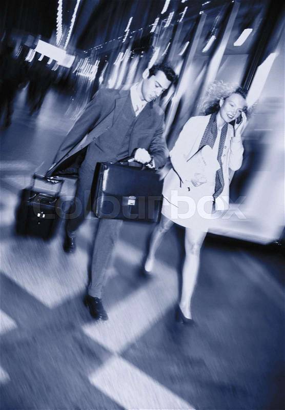 Business couple on the move, stock photo
