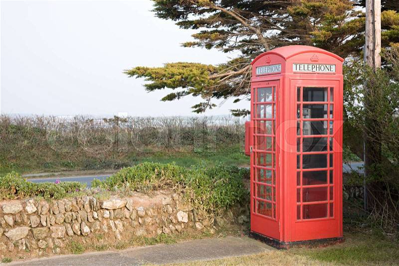 Red telephone box in rural setting, stock photo