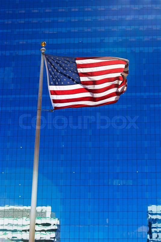 American flag and skyscraper, stock photo