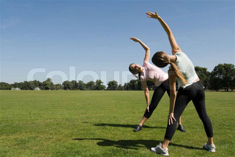 Women exercising in park, stock photo