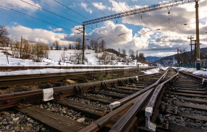 Old railroad in winter mountain on a cloudy day. transportation background, stock photo