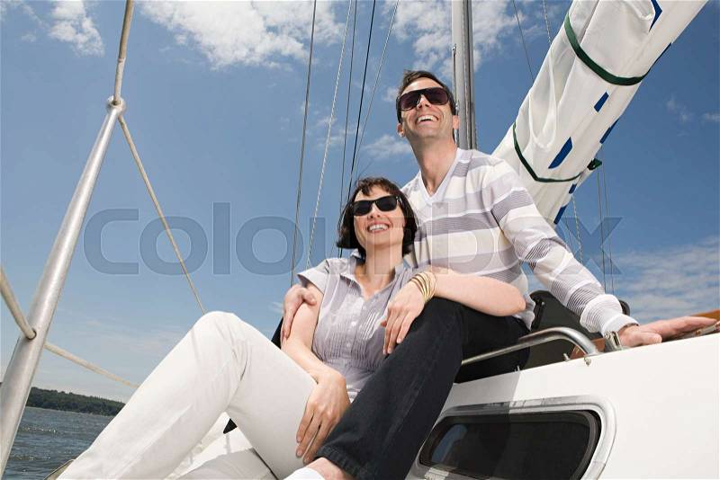 Couple relaxing on a sailing boat, stock photo