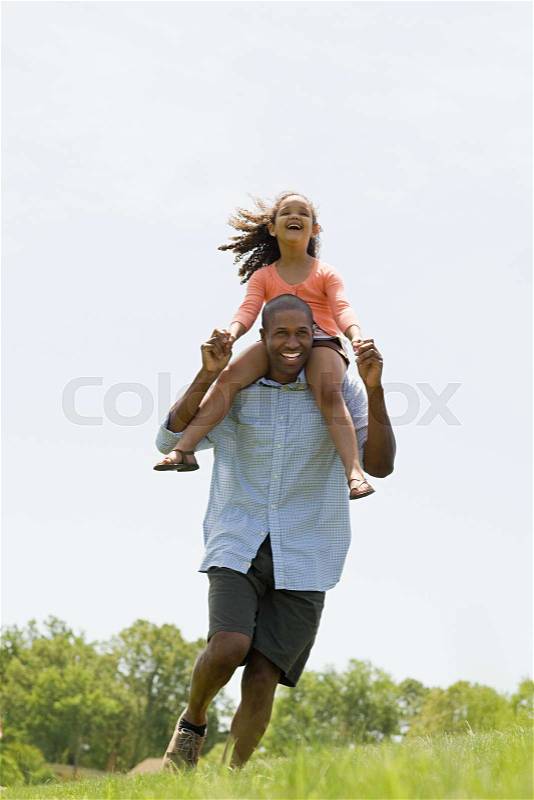 Man carrying daughter, stock photo