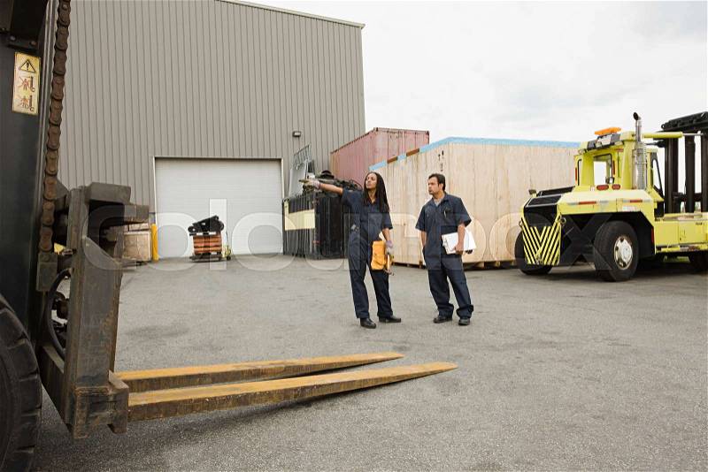 Colleagues in loading bay, stock photo