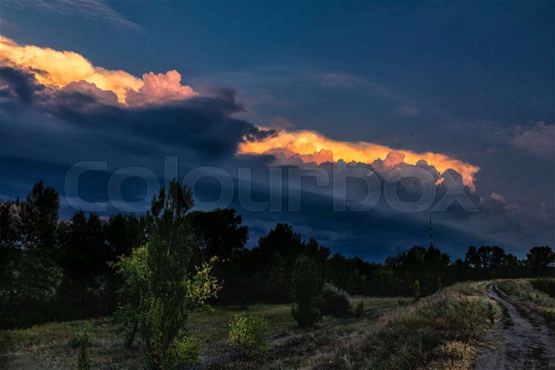 Dark cloud storm. Rain coming on the sky in the rural road view. Beautiful storm sky with dark cloud, stock photo