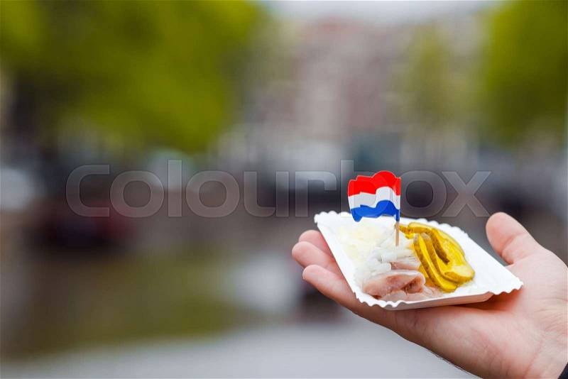 Traditional dutch food: herring fish with onion in fastfood market of Amsterdam, Netherlands, stock photo