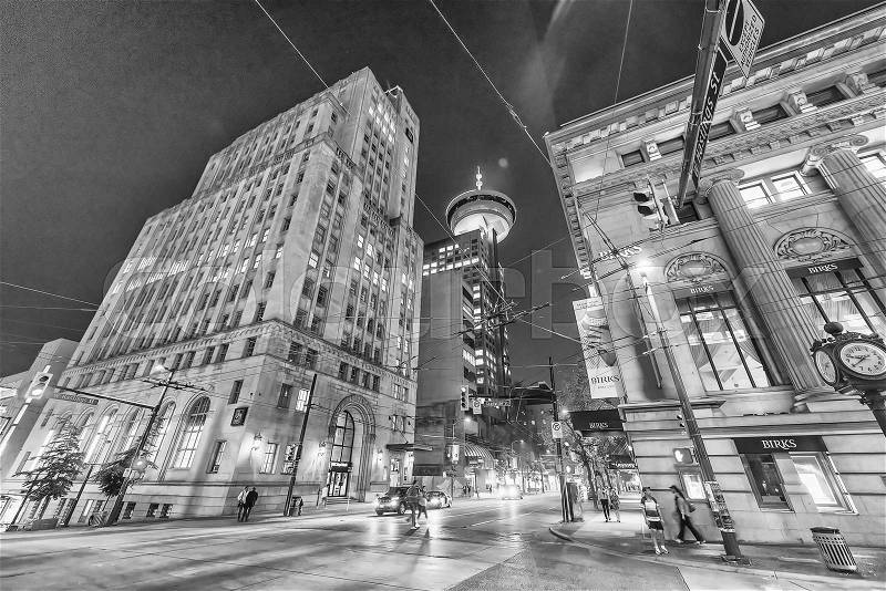 VANCOUVER, CANADA - AUGUST 9, 2017: City streets and buildings at night. Vancouver attracts 15 million tourists annually, stock photo