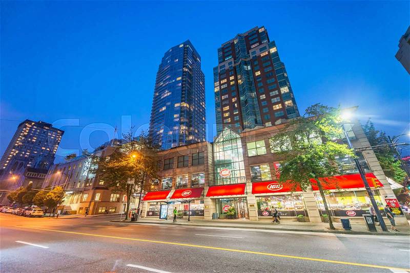 VANCOUVER, CANADA - AUGUST 9, 2017: City streets and buildings at night. Vancouver attracts 15 million tourists annually, stock photo
