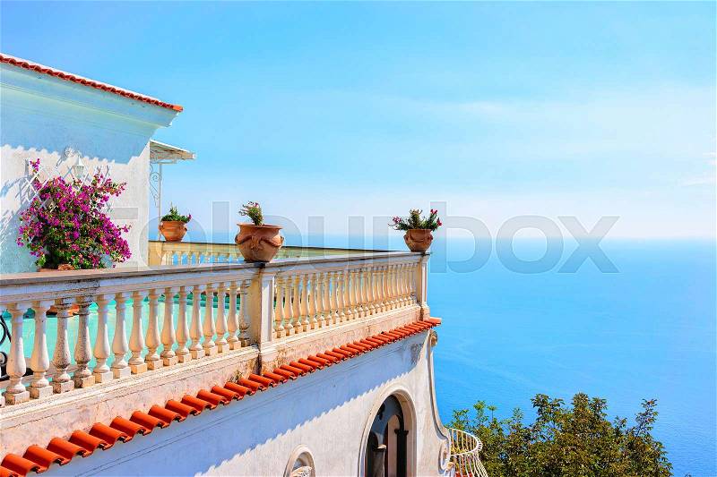 Balcony with flowers and Tyrrhenian sea in Nocelle at Path of Gods, Amalfi coast, Italy, stock photo