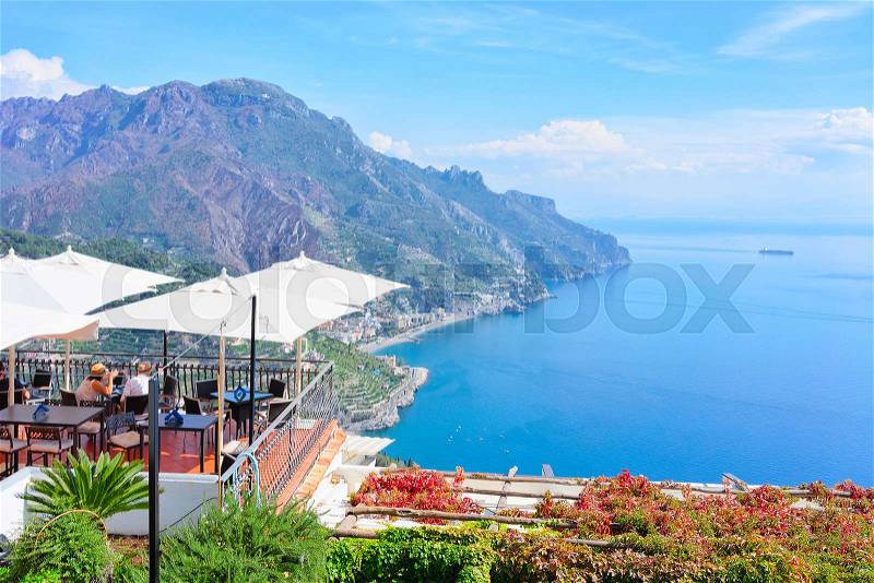 Open air street restaurant with umbrellas in Ravello village, Tyrrhenian sea, Amalfi coast, Italy, stock photo
