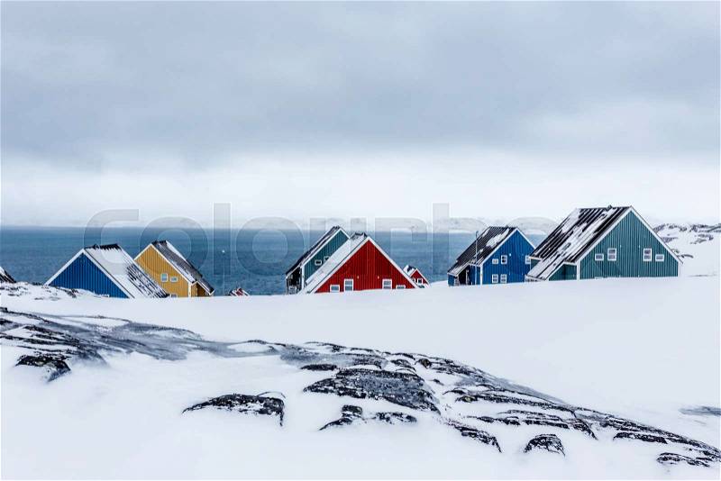 Rows of colorful inuit houses among rocks in a suburb of arctic capital Nuuk, Greenland, stock photo