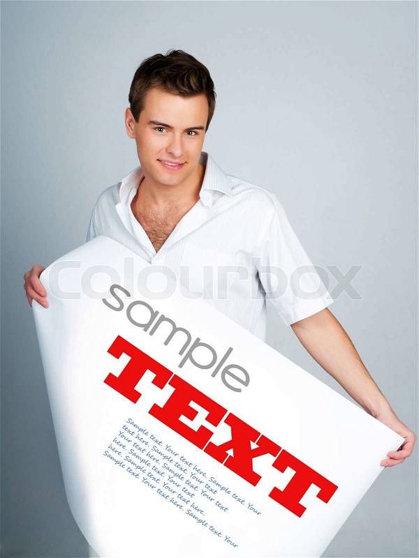 Young man holding a paper with sample text, stock photo