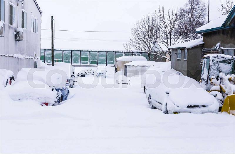 Cars covered with lots of snow during winter in Hokkaido, Japan, stock photo