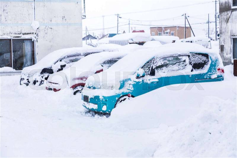 Cars covered with lots of snow during winter in Hokkaido, Japan, stock photo