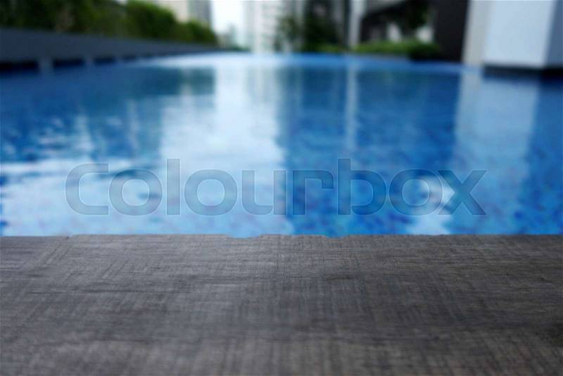 Swimming pool and wooden deck and bricks for the background, stock photo
