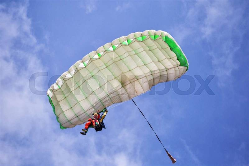 Extreme active paraglider flyng over a blue sky, stock photo