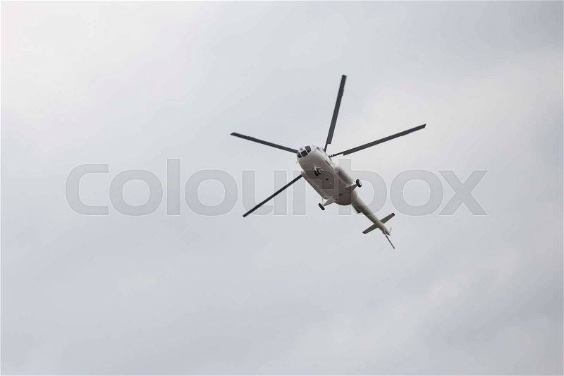 Helicopter in the sky with clouds, stock photo