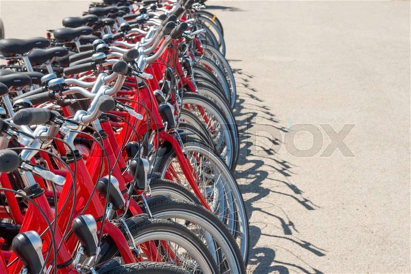 Group of red city bicycles parking on the street, stock photo
