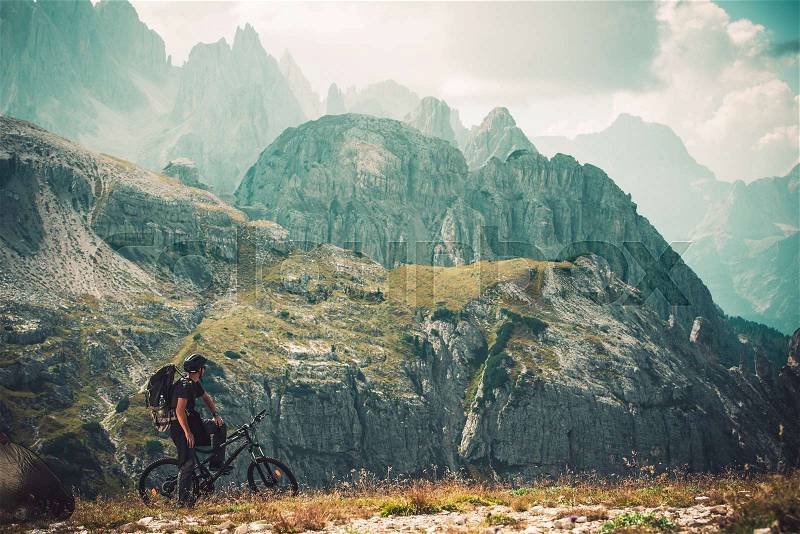 Mountain Trail Bike Trip. Caucasian Sportsman in His 30s on His Performance Bike in the Italian Dolomites. Auronzo Di Cadore, Italy, stock photo