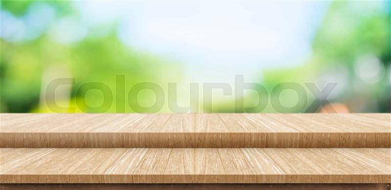 Empty step wood table top food stand with blur green park tree background bokeh light,Mock up for display or montage of product,Banner for advertise on online media,nature business presentation, stock photo