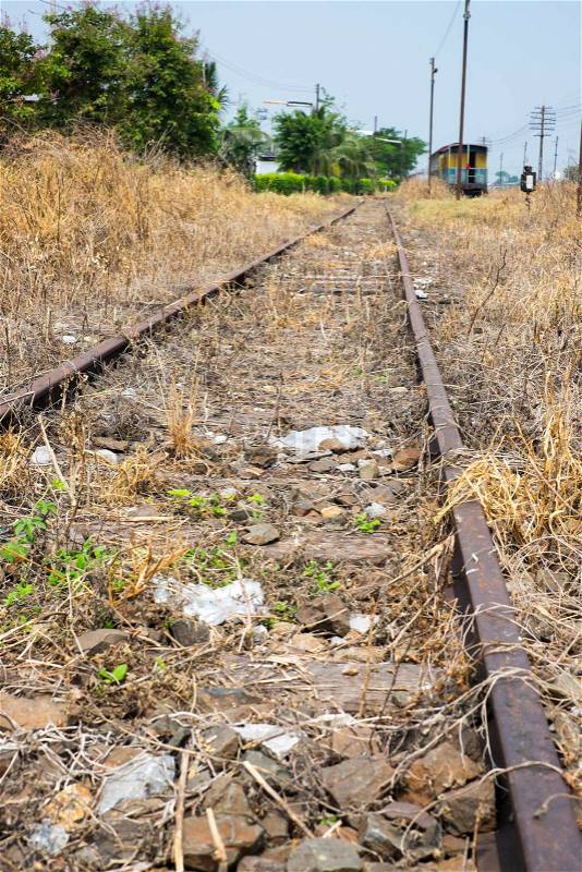 Vacant Rail way switch track with yellow die grass, stock photo