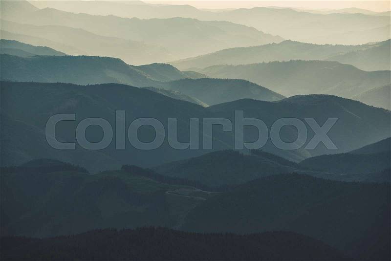 Carpathian mountains summer sunset landscape with abstract gradient of mountain peaks in blue colors, natural travel outdoor background, stock photo