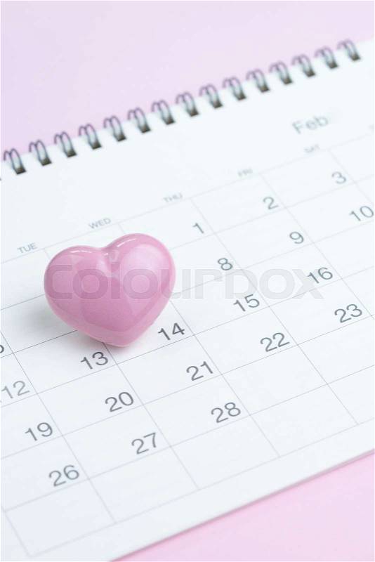 Calendar with cute pink heart shape on 14 February on pink background using as romantic Valentines day concept, stock photo
