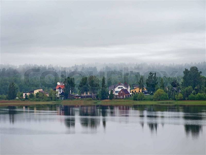 Group of houses in the forest near the river, stock photo