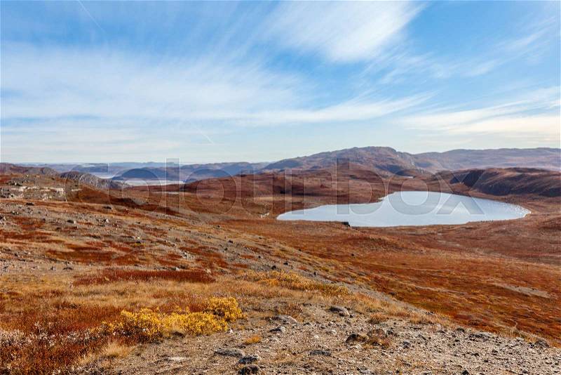 Autumn greenlandic wastelands landscape with lakes and mountains in the background, Kangerlussuaq, Greenland, stock photo