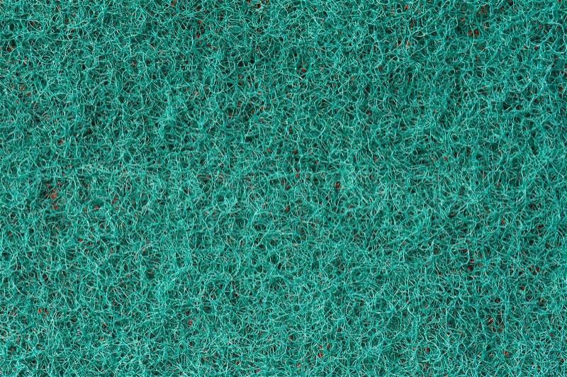 Close-up of a green cleaning sponge surface as a backdrop, stock photo