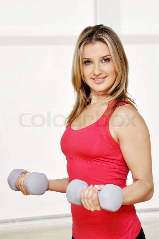 Fitness sport girl smiling happy. Fitness woman lifting dumbbells, stock photo
