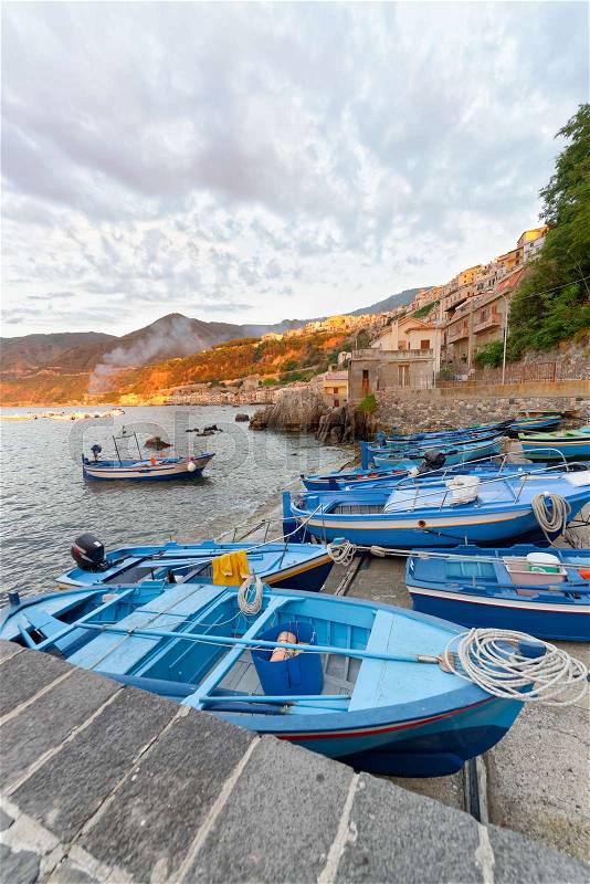 Scilla, Calabria. Docked boats in the city port at summer sunset, Italy, stock photo