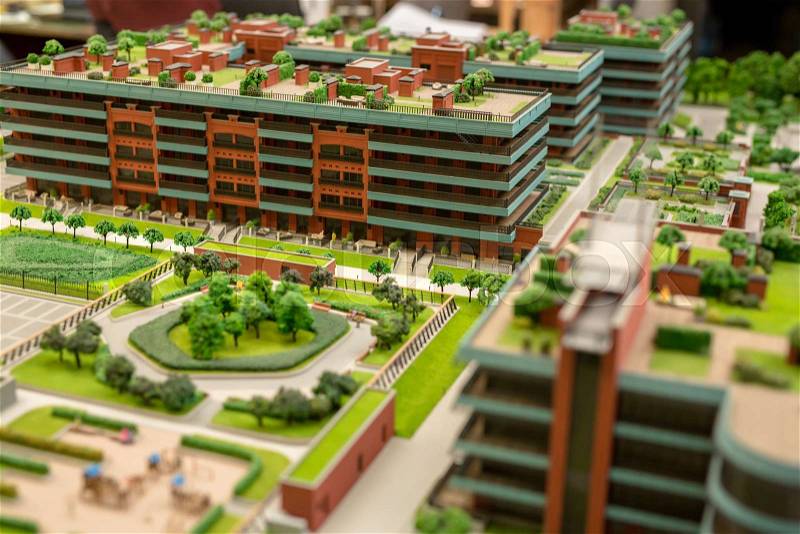 Architectural layout model of modern city with buildings and vegetation, stock photo