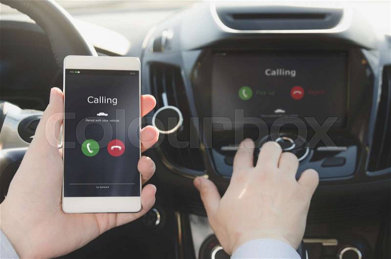 Man using phone calling system in car. Hand-free safety driving, stock photo