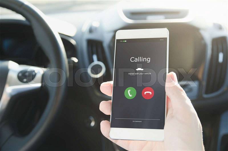 Man using phone calling system in car. Hand-free safety driving, stock photo