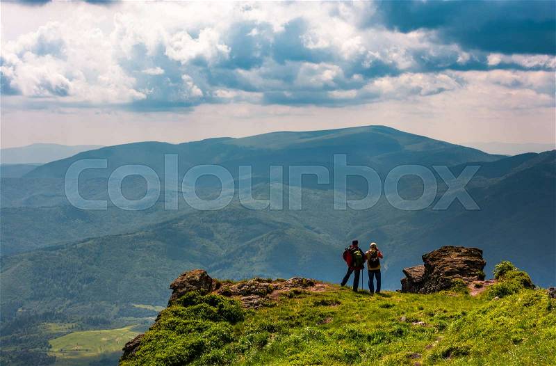 Tourists stand on cliff enjoying the view. gorgeous view of magnificent Polonina Runa ridge from the hills of Pikui mountain. Location Ukrainian Carpathians, stock photo