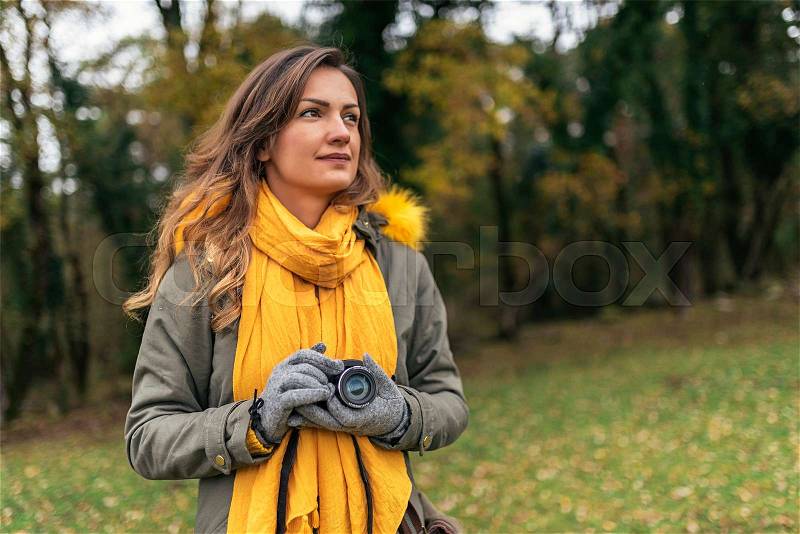 Young woman using a camera to take photo at the forest, stock photo