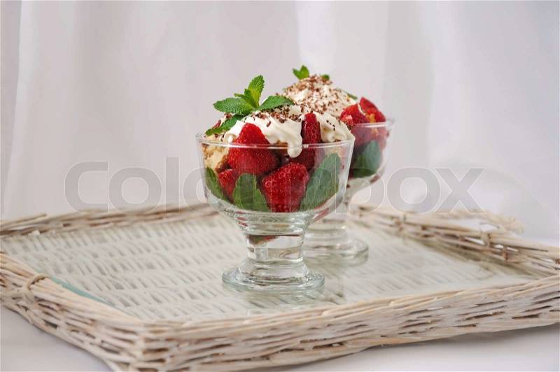 Strawberries with biscuit pieces with mint whipped cream with a grated chocolate, stock photo