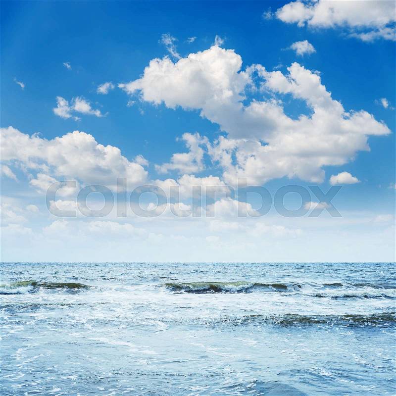 Blue sky with waves and clouds over it, stock photo
