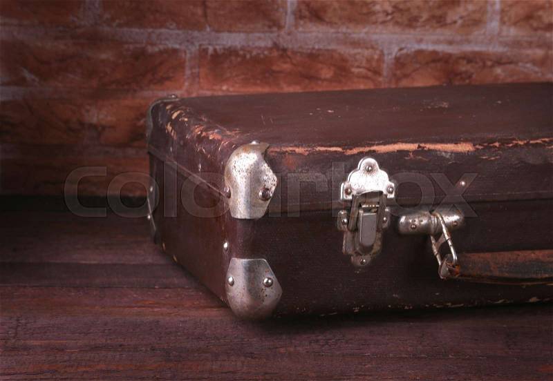 Travel concept with Vintage suitcase old camera on wooden floor, stock photo