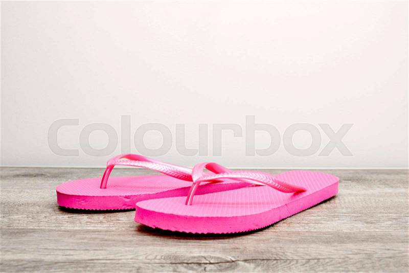 A studio photo of pink flip flops, stock photo