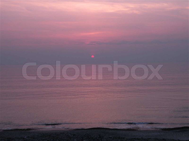 Pink red glowing sun, sunset at the sea, north sea, Thy Nationalpark, Jutland, Denmark, stock photo