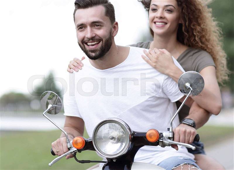Happy couple driving scooter excited on summer holidays vacation, stock photo